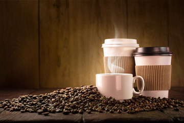 Coffee cup and coffee beans on wooden table
