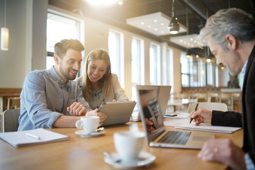 Mixed sales team preparing pitch on work trip