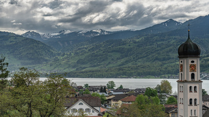 Fototapeta premium Switzerland, view on village, lake and Alps