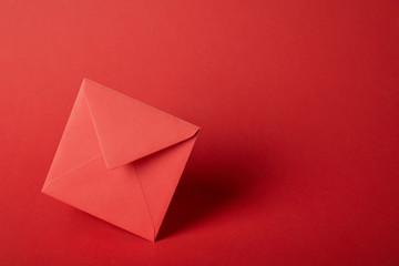 bright, colorful and empty envelope on red background with copy space