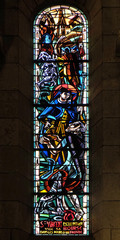 St Vincent empties his purse in the hands of a poor, stained glass window in Basilica of the Sacre...