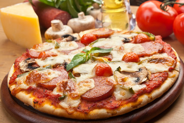 salami, mushroom and vegetable pizza with ingredients