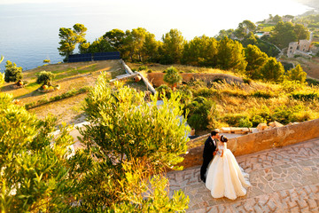 Beautiful wedding couple walking on the  old street. outdoor