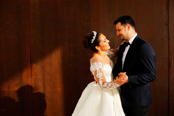 Beautiful wedding couple posing in sun