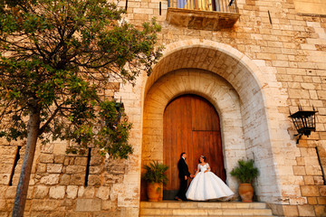 Beautiful wedding couple posing in front of old door