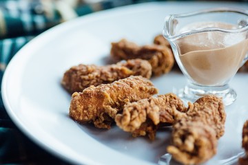 Nuggets with sauce on a white plate