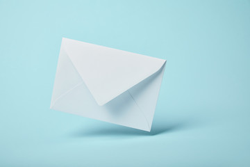 white and blank envelope on blue background with copy space