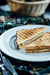 Triangular toast sandwiches with lettuce and ham on a plate