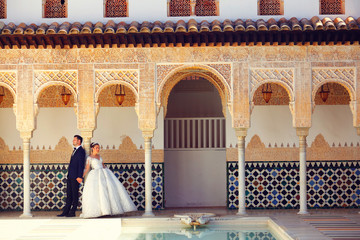 Wedding couple posing in old arabic house
