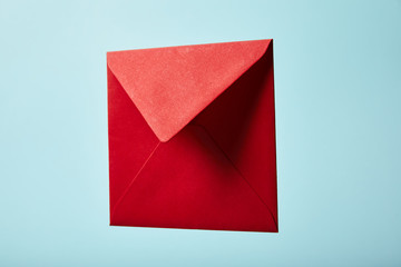 red and colorful envelope on blue background with copy space