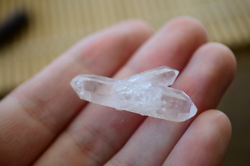 Clear Quartz points being held in woman's hand. Healing quartz points, bright colors. Healing...