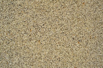 Black , white , yellow  small stone bond by concrete wall background texture
