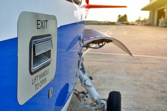 Helicopter parking on ramp. Helicopter   outside door handle sign . Helicopter in front of hangar 