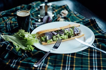 Sandwich with tomatoes, onions and cheese on a plate