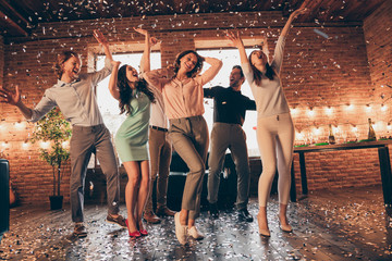 Full length body size view of nice company pretty charming attractive cheerful glad positive guys ladies having fun disco flying decorative elements rejoicing in industrial loft interior house - obrazy, fototapety, plakaty