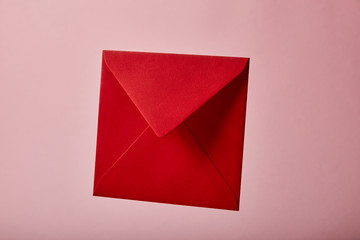 red and empty envelope on pink background with copy space