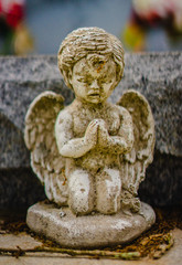 A aged white alabaster angelic angel statue on a grave praying. It is about 4 inches tall in...
