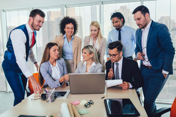 Fototapeta premium Group of young business people working together in creative office. Selective focus.