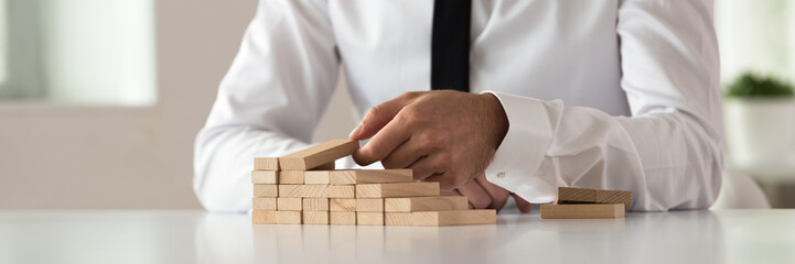 Wide view image of business executive building steps of wooden pegs