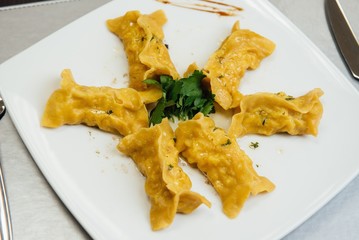 maultaschen and greens on a plate on the table