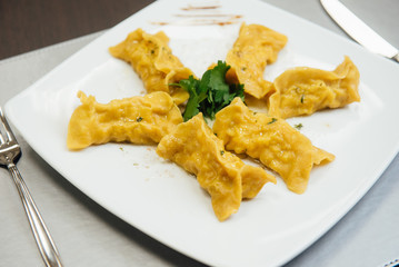 maultaschen and greens on a plate on the table