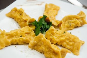 maultaschen and greens on a plate on the table
