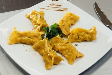maultaschen and greens on a plate on the table
