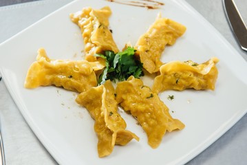 maultaschen and greens on a plate on the table