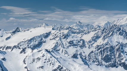 Switzerland, panorama view from Titlis mountain on Alps and mountains above white clouds