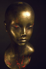 Closeup studio shot of colored woman mannequin with stylish decoration, dark background