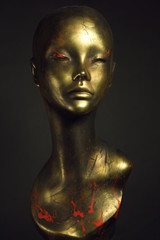 Fototapeta na wymiar Closeup studio shot of colored woman mannequin with stylish decoration, dark background