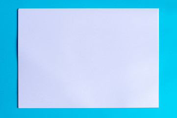 stack of white sheets of paper on multicolored backgrounds top view