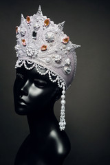 Head of mannequin in creative Russian white kokoshnick with jewels