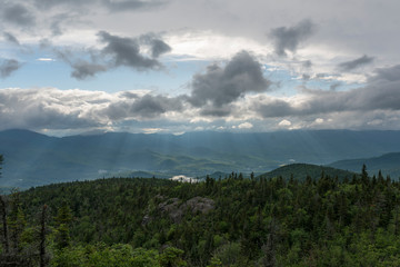 sun rays breaking out over the lush green landscape