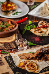 Georgian cuisine. A large laid table of different dishes for the whole family on a day off. Kebab, Lula, Lavash, Suluguni cheese, Khachipuri, Khinkali.