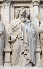 Obraz premium Saint John the Apostle, statue on the facade of Saint Augustine church in Paris, France 