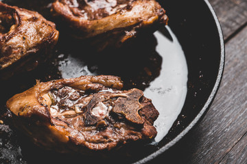 Grilled meat on the frying pan. Selective focus.