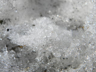 Thawed patch in the snow. Melting snow. Spring, slush, melted snow