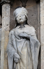 Saint Marcel statue on the portal of the Saint Germain l'Auxerrois church in Paris, France 