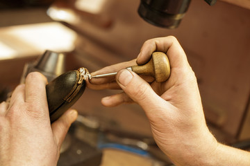 Professional jeweler repairing jewelry at his workshop