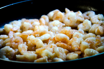 Ready cooked prawns on a frying pan. Healthy eating or dieting concept.