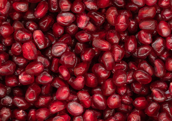 Texture of red peeled pomegranate background