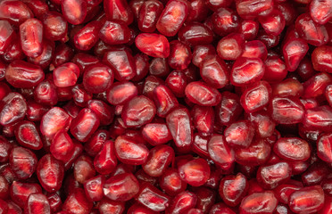 Texture of red peeled pomegranate background