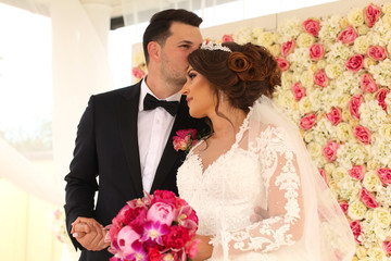 Bride and groom holding their marriage certificate