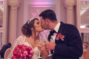 Bride and groom holding their marriage certificate