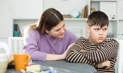 Mother wants to talk with his son after  conflict at table