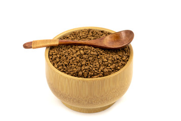 Granulated coffee in a wooden mug with a spoon on a white background