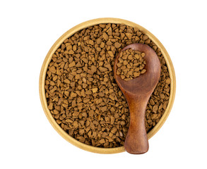 Granulated coffee in a wooden mug with a spoon on a white background