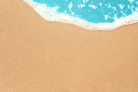 Sea sand and surf texture background. Vacation on ocean beach, summer holiday concept