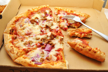 Eating Meat Pizza with Onions in a Takeout Box 